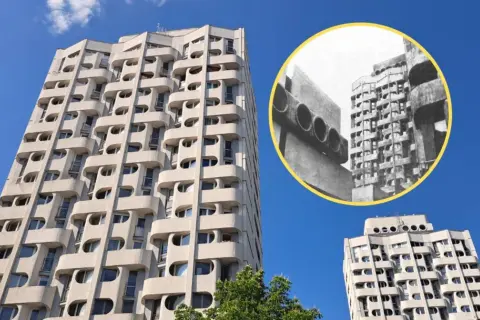 Wrocławski Manhattan: charakterystyczne bloki z lat 70. z falującymi balkonami i okrągłymi oknami, na tle błękitnego nieba.