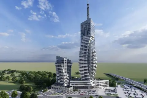 Nowoczesne wieżowce w Rzeszowie, w tym rzeszów najwyższy budynek, z charakterystyczną, skręconą fasadą i anteną na szczycie. Otoczone zielenią i parkingiem.