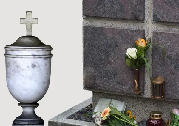 Kamienna urna z krzyżem i kwiaty przy ścianie kolumbarium.